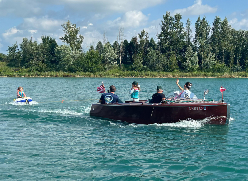 2 year old Addison tubing behind Stephen Gerding's 1946 17 Utility